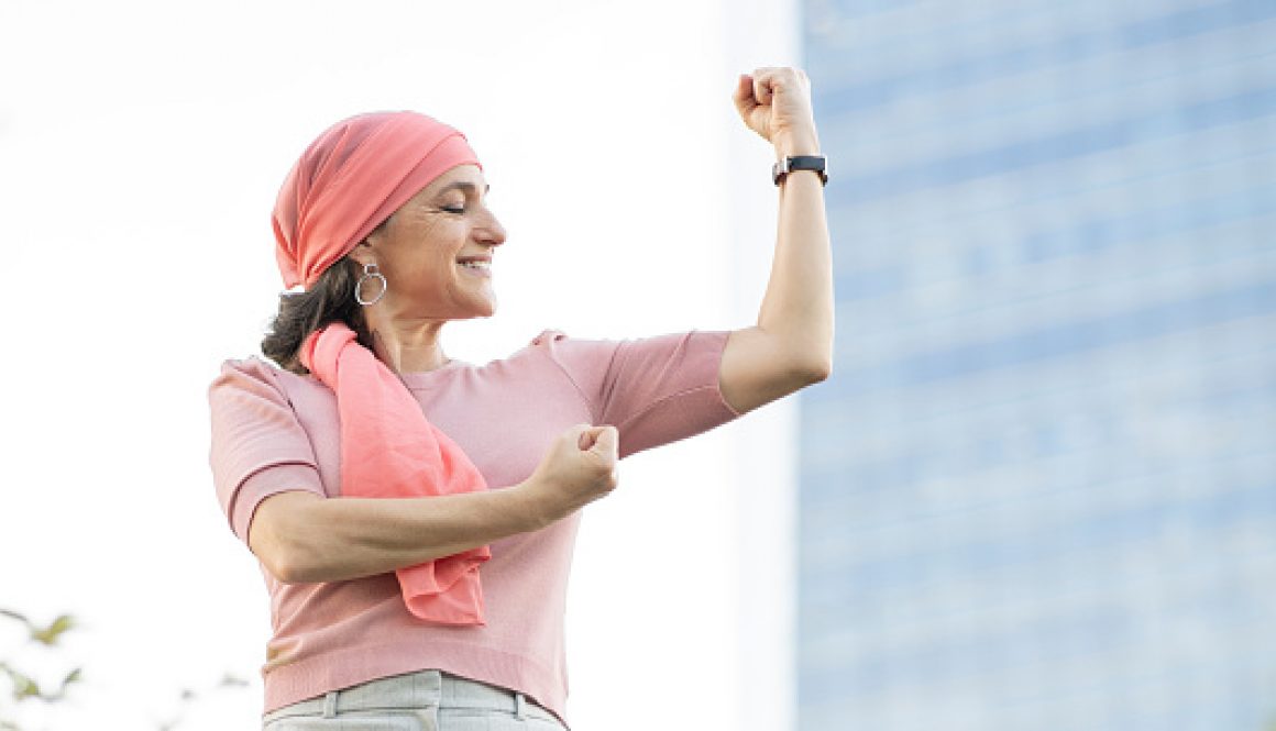 woman with pink headscarf fighting cancer