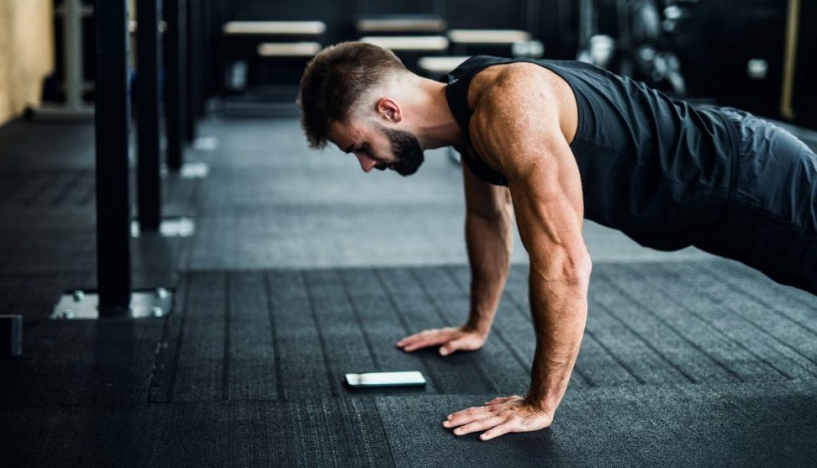 Man using phone in a gym