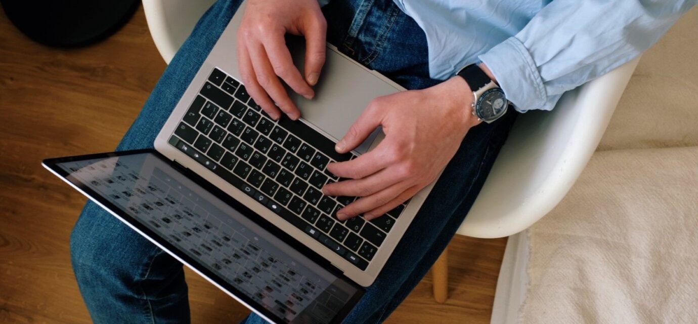 Person typing on a laptop while building a WordPress website