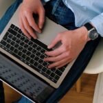 Person typing on a laptop while building a WordPress website