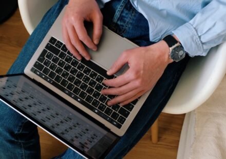 Person typing on a laptop while building a WordPress website
