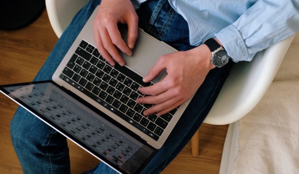 Person typing on a laptop while building a WordPress website