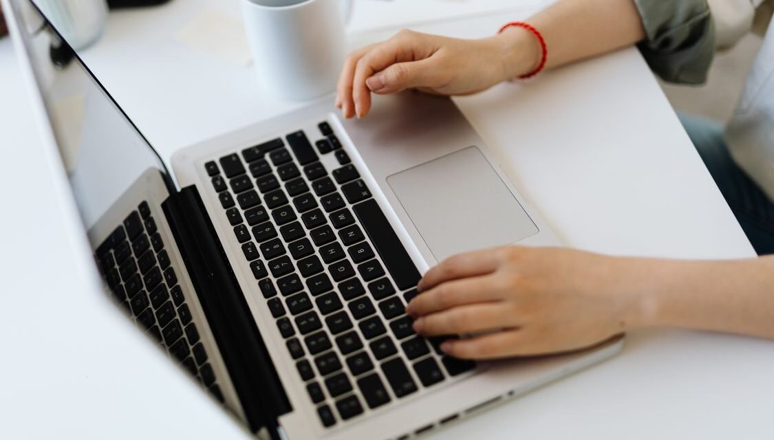 Person typing on a laptop while installing WordPress