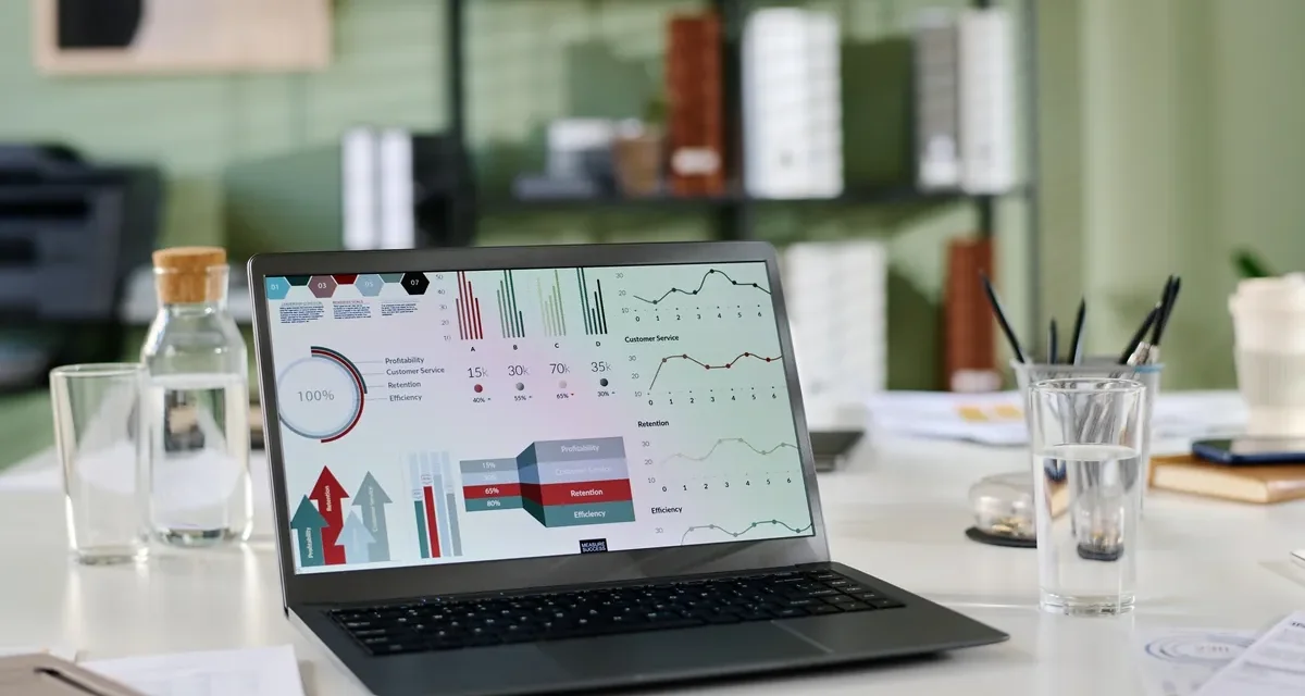 Laptop showing website analytics and charts on a desk