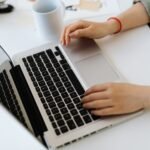 Person typing on a laptop while installing WordPress