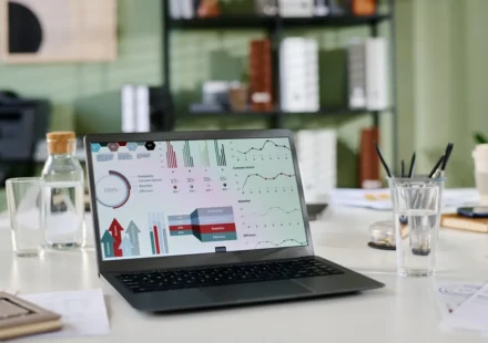 Laptop showing website analytics and charts on a desk