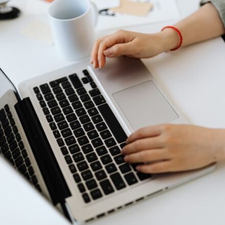 Person typing on a laptop while installing WordPress