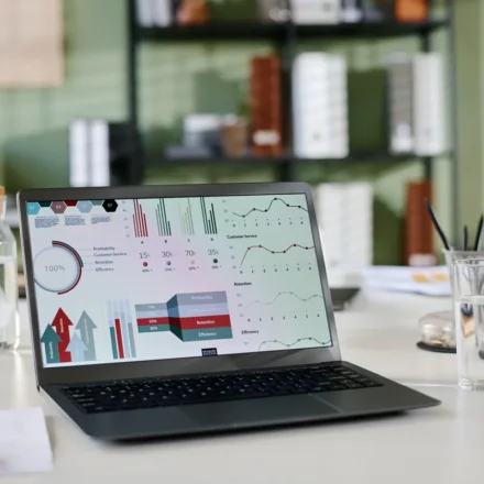 Laptop showing website analytics and charts on a desk