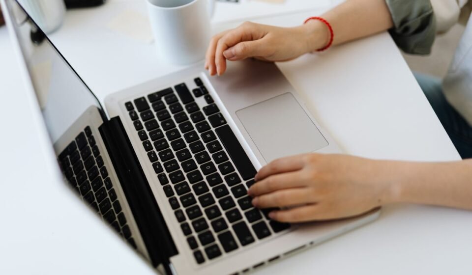 Person typing on a laptop while installing WordPress